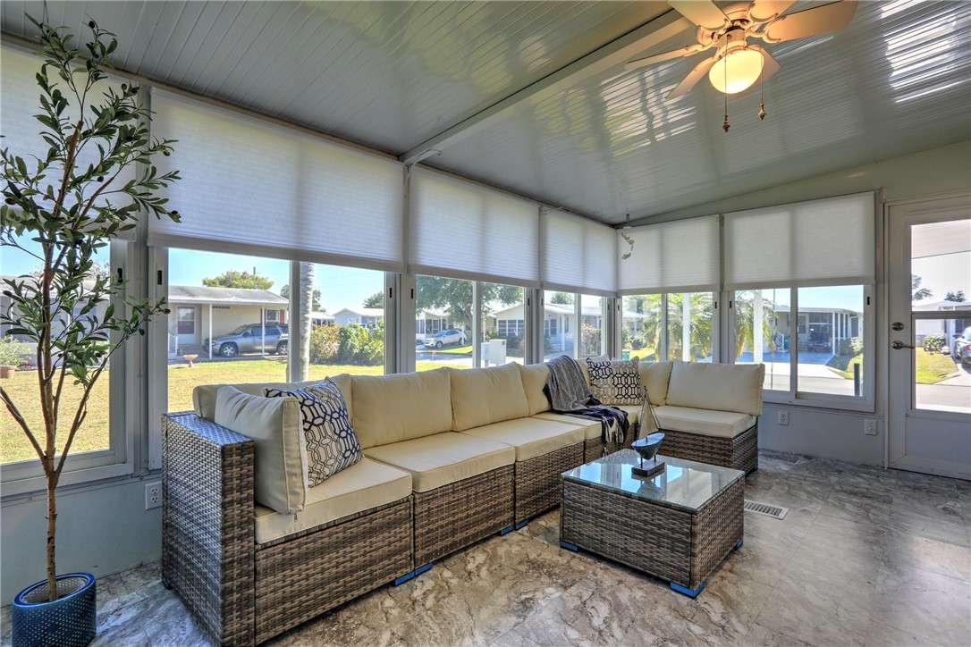 7519 Chasta Road Micco, FL 32976 - Photo 21 of 27 a living room with furniture a large window and a fireplace