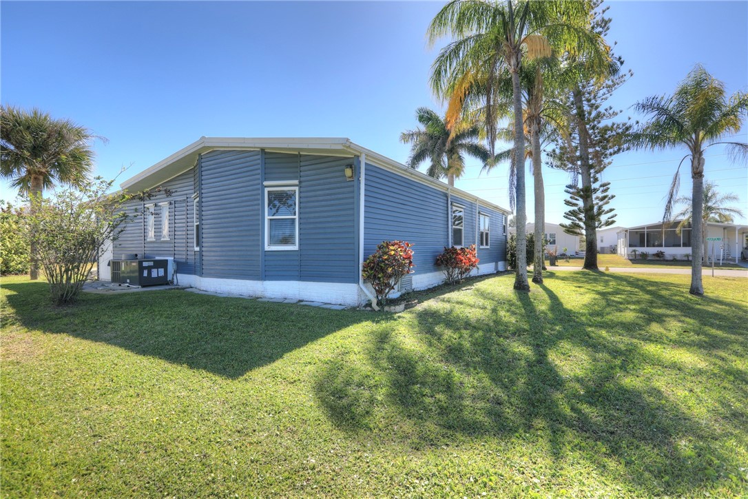 7519 Chasta Road Micco, FL 32976 - Photo 3 of 27 a backyard of a house with table and chairs
