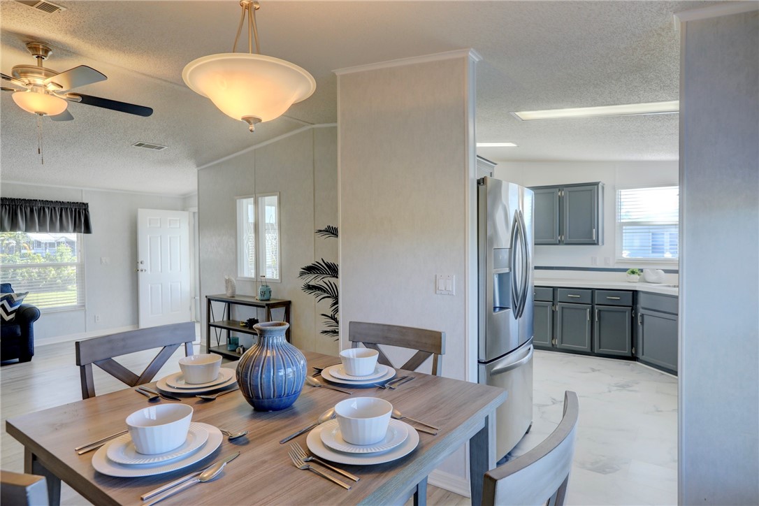 7519 Chasta Road Micco, FL 32976 - Photo 7 of 27 a kitchen with a dining table and chairs