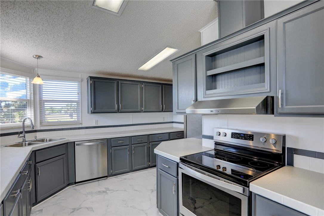 7519 Chasta Road Micco, FL 32976 - Photo 10 of 27 a kitchen with a stove and a sink