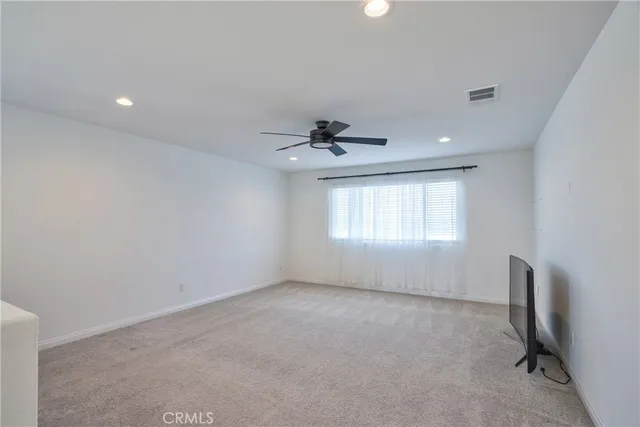 a bed room with a bed and a ceiling fan