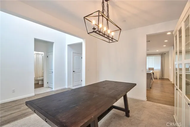 a view of an empty room with stairs wooden floor and a ceiling fan