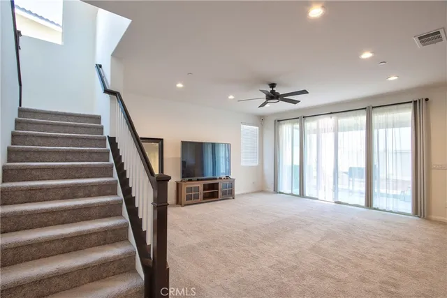 a large kitchen with stainless steel appliances kitchen island a refrigerator and a stove top oven