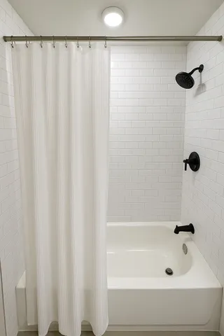 a bathroom with a shower and a shower curtain