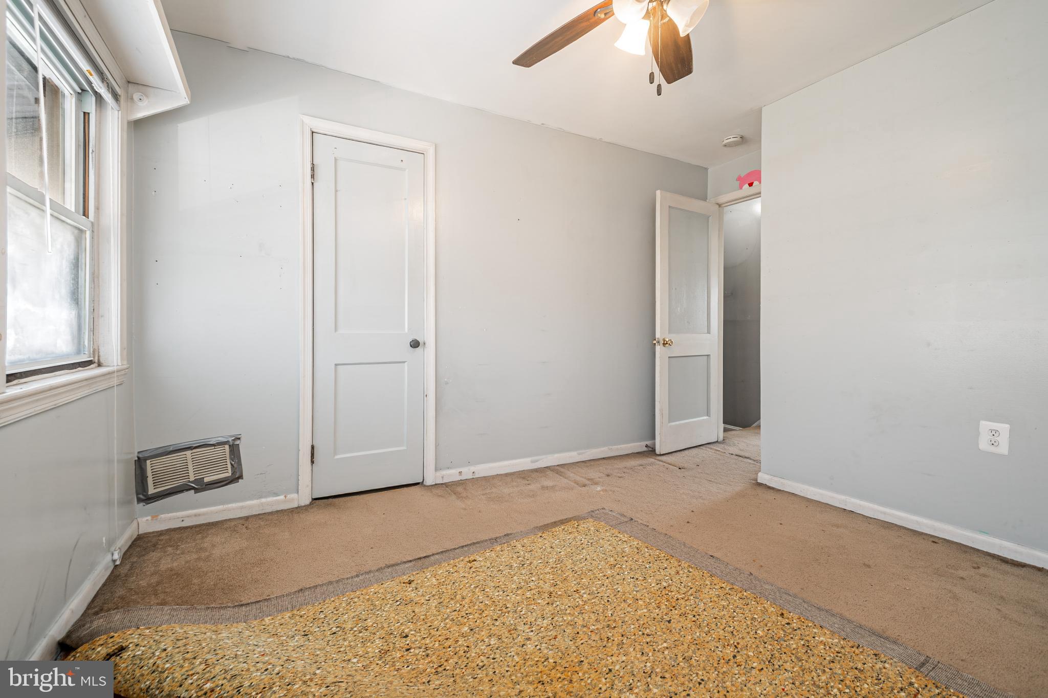 1217 Anglesea Street Baltimore, MD 21224 - Photo 14 of 25 an empty room with windows and closet