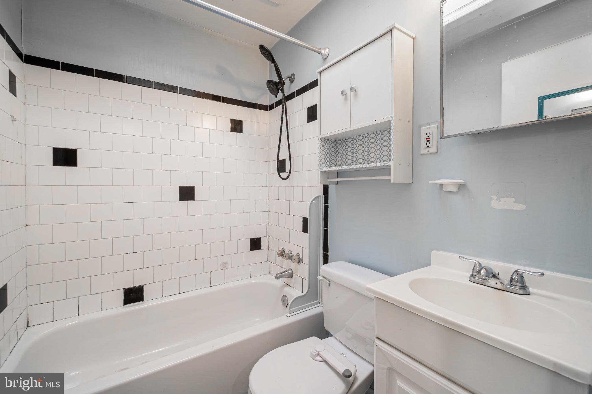 1217 Anglesea Street Baltimore, MD 21224 - Photo 15 of 25 a bathroom with a sink a toilet and a bathtub