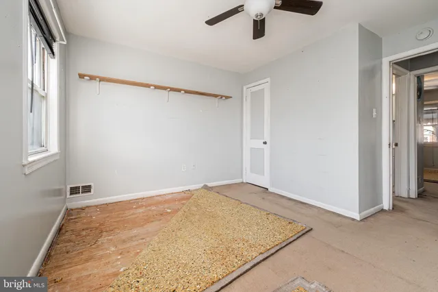 an empty room with a empty space and windows