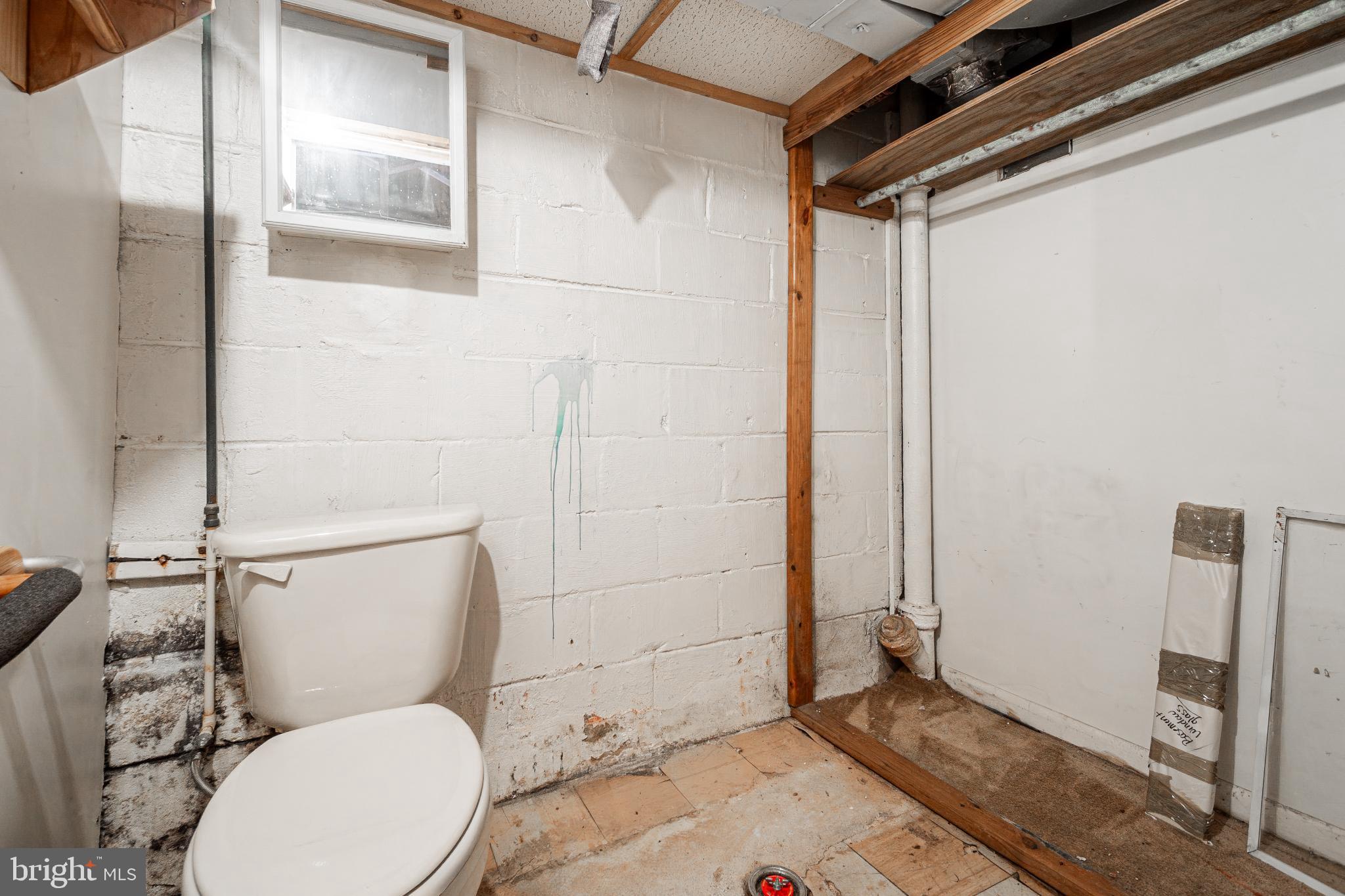 1217 Anglesea Street Baltimore, MD 21224 - Photo 21 of 25 a bathroom with a toilet and a shower