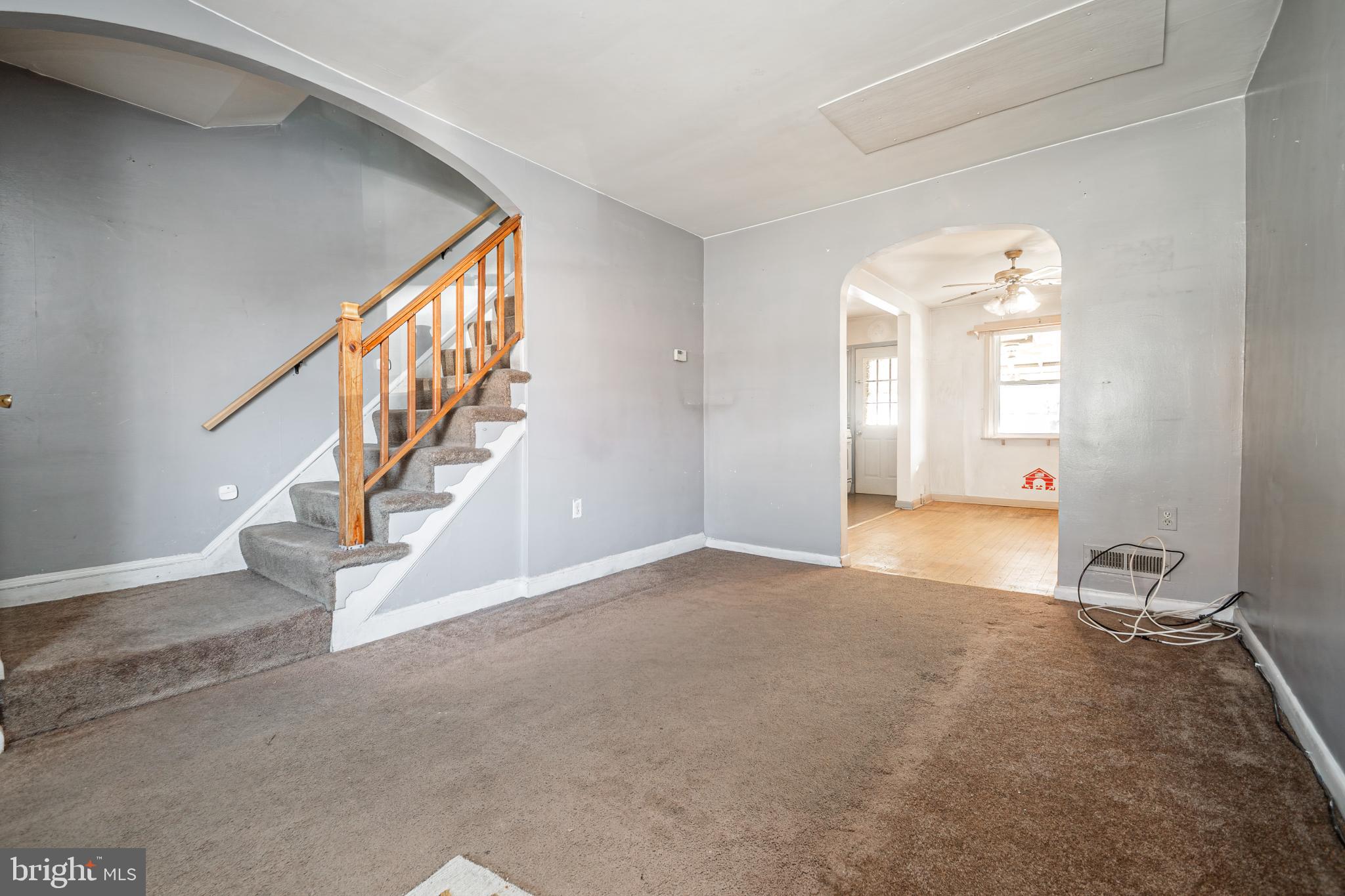 1217 Anglesea Street Baltimore, MD 21224 - Photo 3 of 25 a view of an empty room with stairs and a window