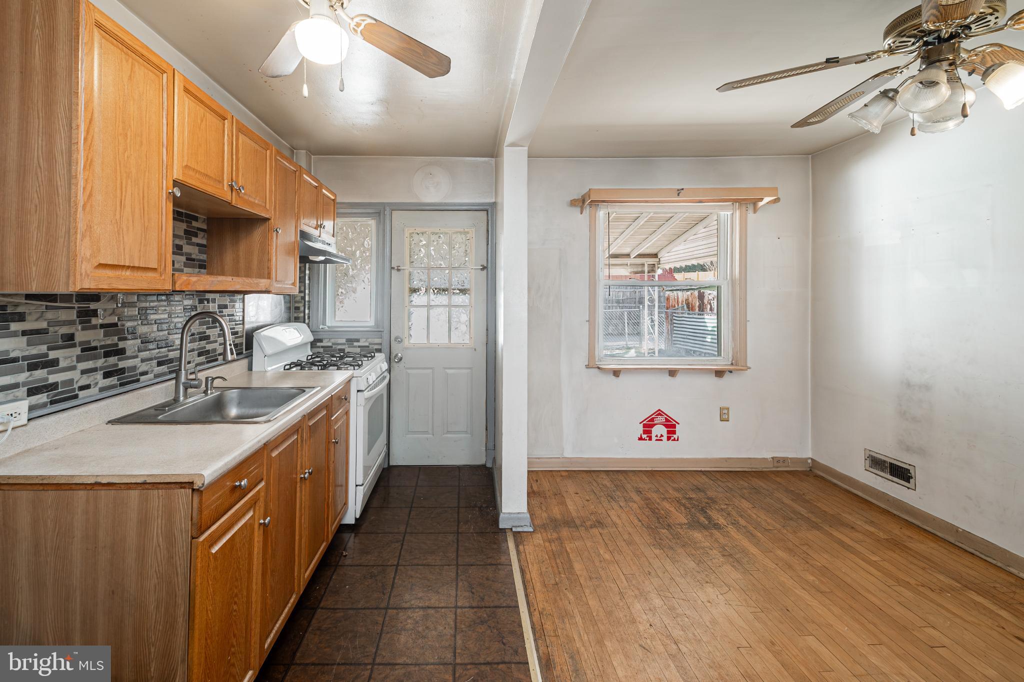 1217 Anglesea Street Baltimore, MD 21224 - Photo 7 of 25 a kitchen with wooden cabinets and sink