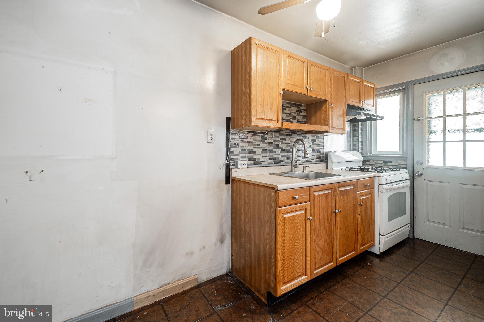 1217 Anglesea Street Baltimore, MD 21224 - Photo 8 of 25 a bathroom with a granite countertop sink and a mirror