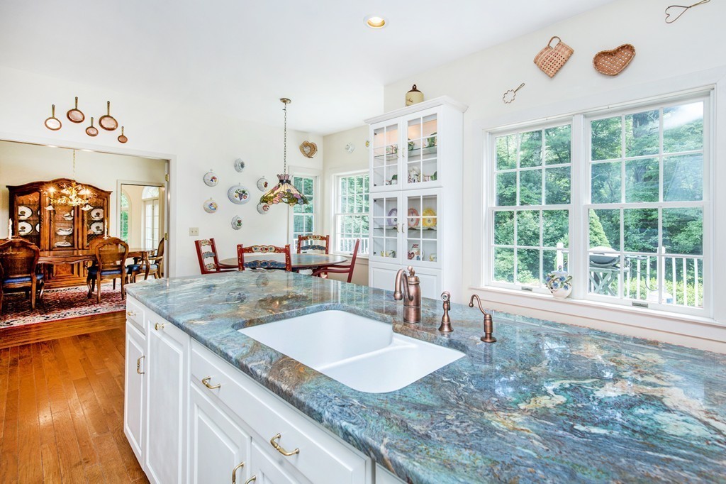 12 Dana Road Boxford, MA 01921 - Photo 5 of 26 a bathroom with a granite countertop sink and a large mirror next to a window
