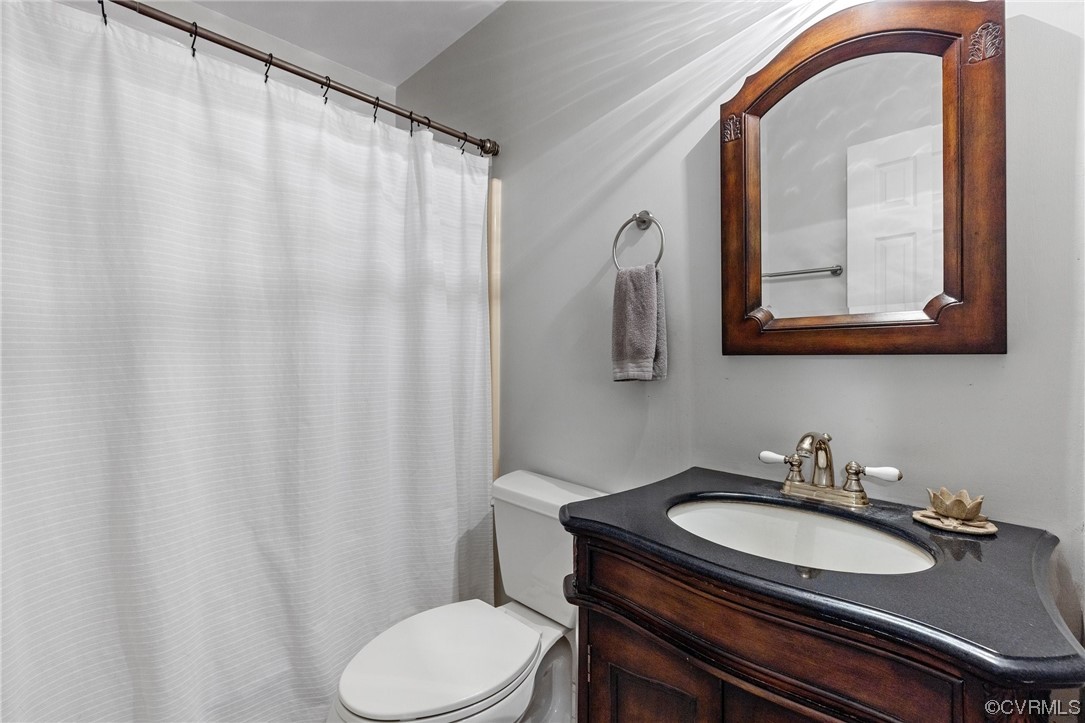 19850 Templeton Road Carson, VA 23830 - Photo 26 of 49 a bathroom with a granite countertop sink vanity mirror and toilet