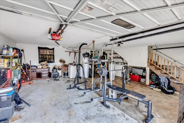 a view of a hallway with wooden floor and a workspace