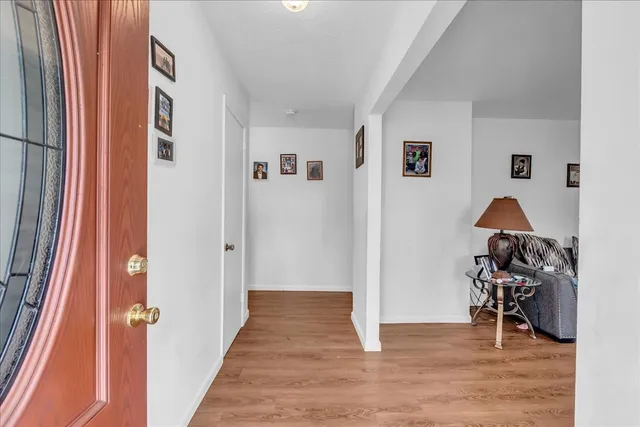 a living room with furniture a ceiling fan and a window