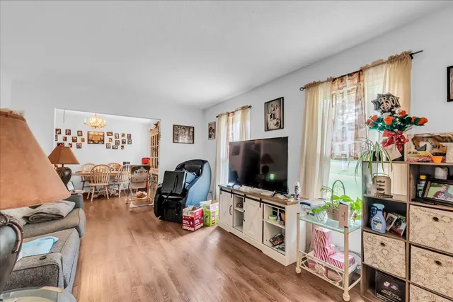 a kitchen with stainless steel appliances a white cabinets and wooden floors