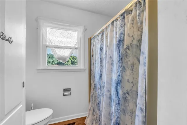 a roof deck with table and chairs and wooden floor
