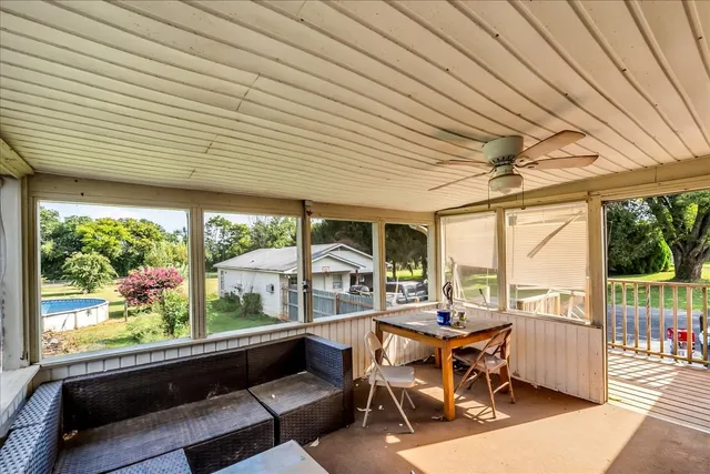 a view of a swimming pool with an outdoor space and seating area