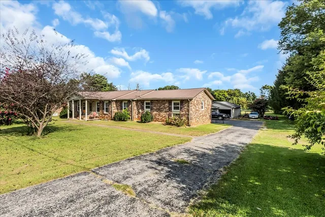 a front view of a house with a big yard