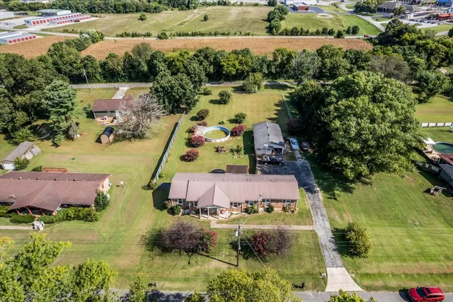 an aerial view of house with a yard and lake view