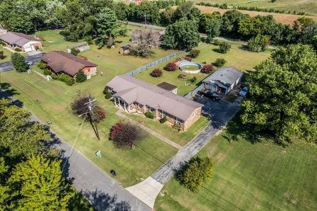 an aerial view of a house with yard swimming pool and outdoor seating