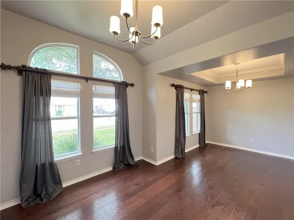 a view of a livingroom with a hardwood floor and a ceiling fan