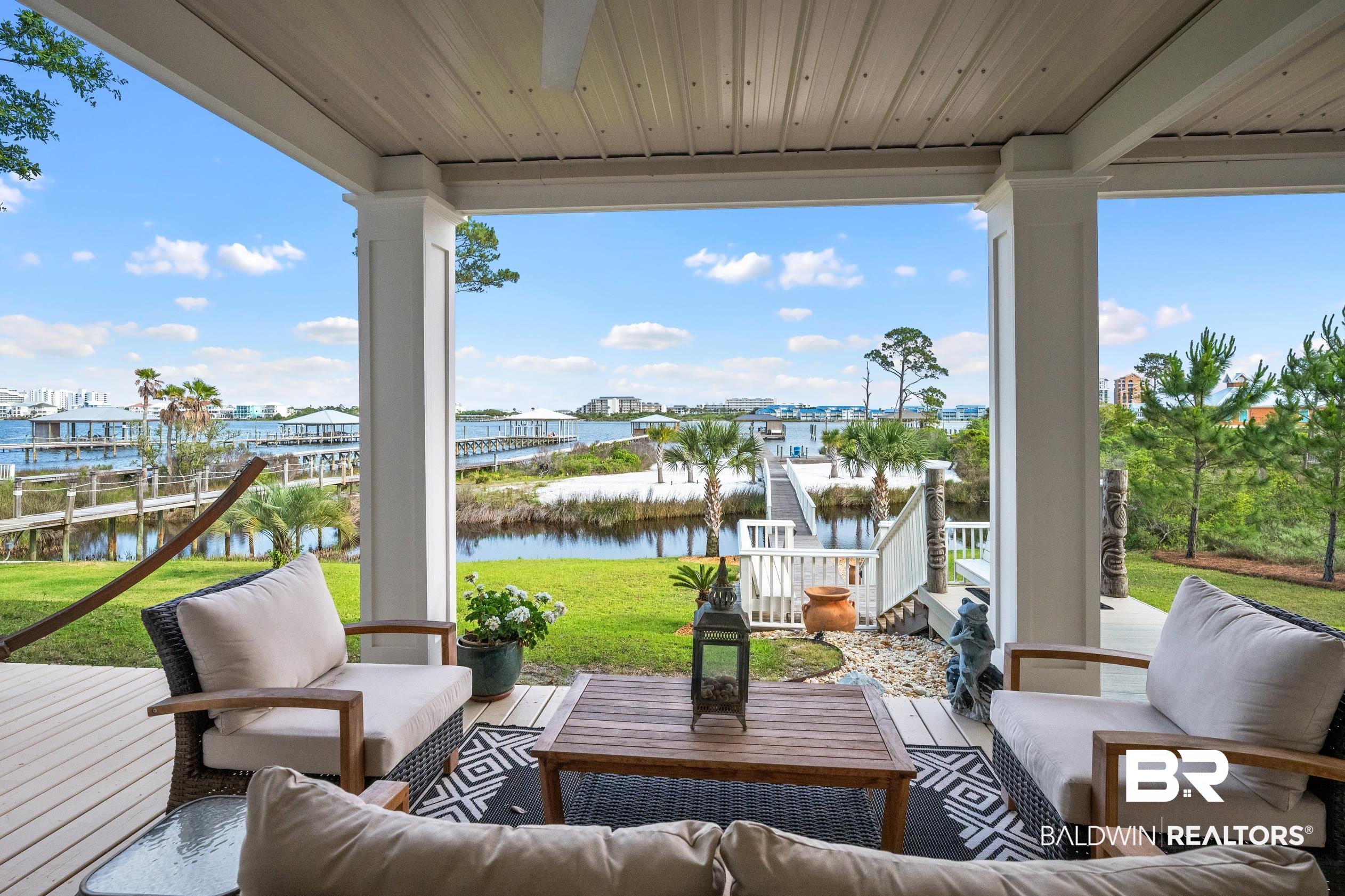 30954 River Road Orange Beach, AL 36561 - Photo 46 of 59 Sunroom / solarium with a water view, wooden ceiling, floor to ceiling windows, and wood finished floors