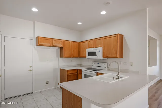 a kitchen with stainless steel appliances granite countertop wooden cabinets a sink and dishwasher