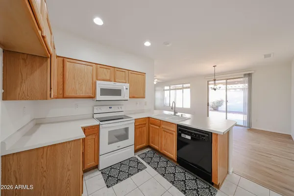 a kitchen with stainless steel appliances granite countertop wooden cabinets a sink and dishwasher