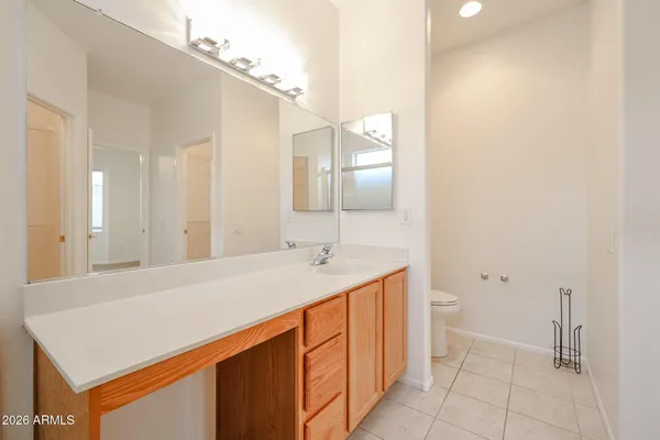a spacious bathroom with a double vanity sink and a mirror