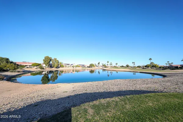 a view of a lake with houses in the back