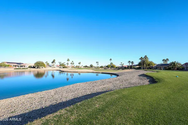 a view of swimming pool with outdoor seating and covered with trees