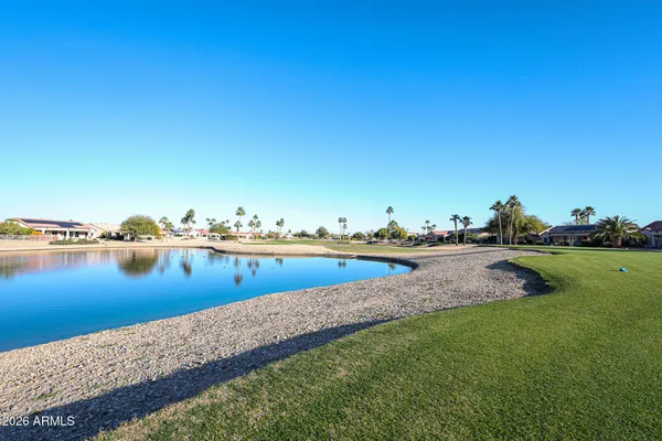 a view of a lake with boats and trees in the background