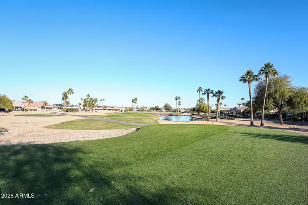 a view of a lake with boats and trees in the background