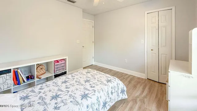 a bedroom with a bed and a book shelf