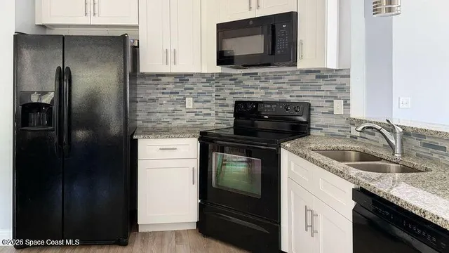 a kitchen with a sink stove and refrigerator