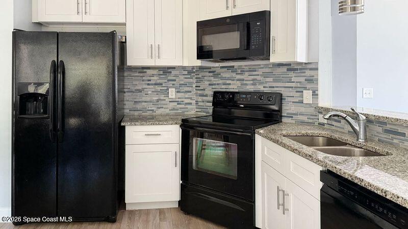 544 Plumbago Road Northwest Palm Bay, FL 32907 - Photo 6 of 14 a kitchen with a sink stove and refrigerator