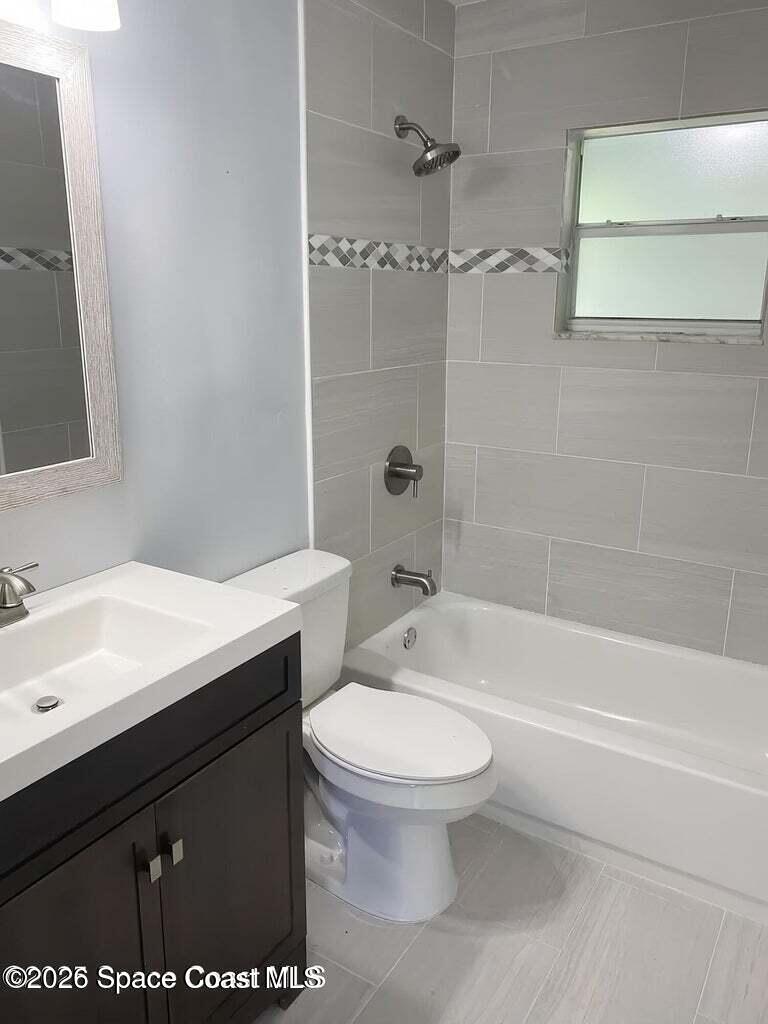 544 Plumbago Road Northwest Palm Bay, FL 32907 - Photo 7 of 14 a bathroom with a sink a toilet and shower