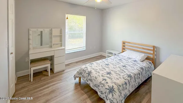 a bedroom with a bed and a chair