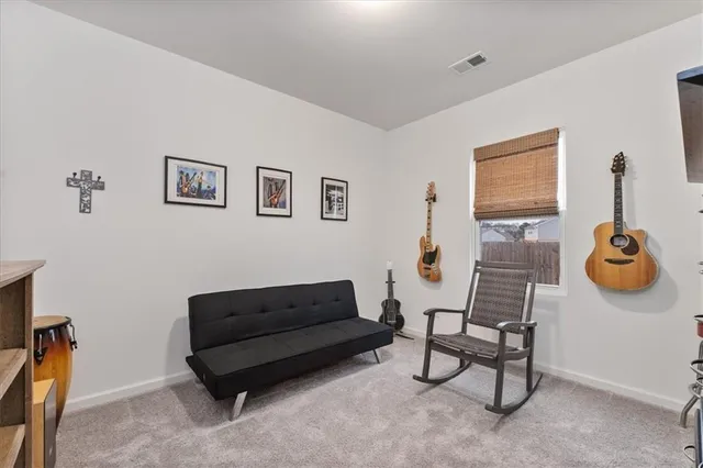 a living room with furniture and a wall painting