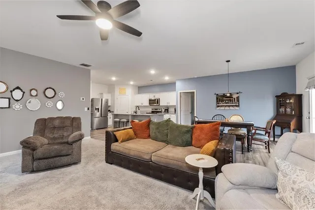 a living room with furniture and kitchen view