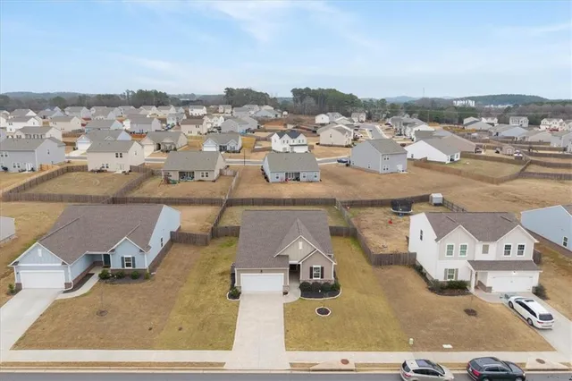an aerial view of residential houses with city view