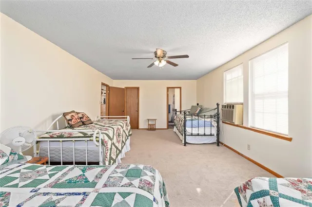 a bedroom with a bed and a dresser with the potted plant