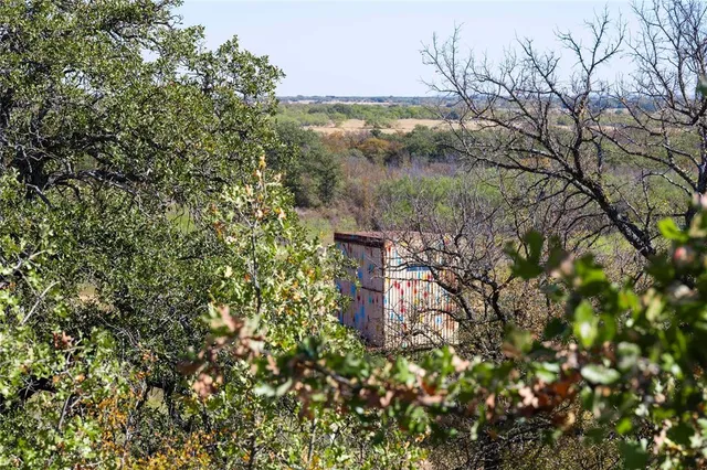 a view of a dry space with a mountain in the background