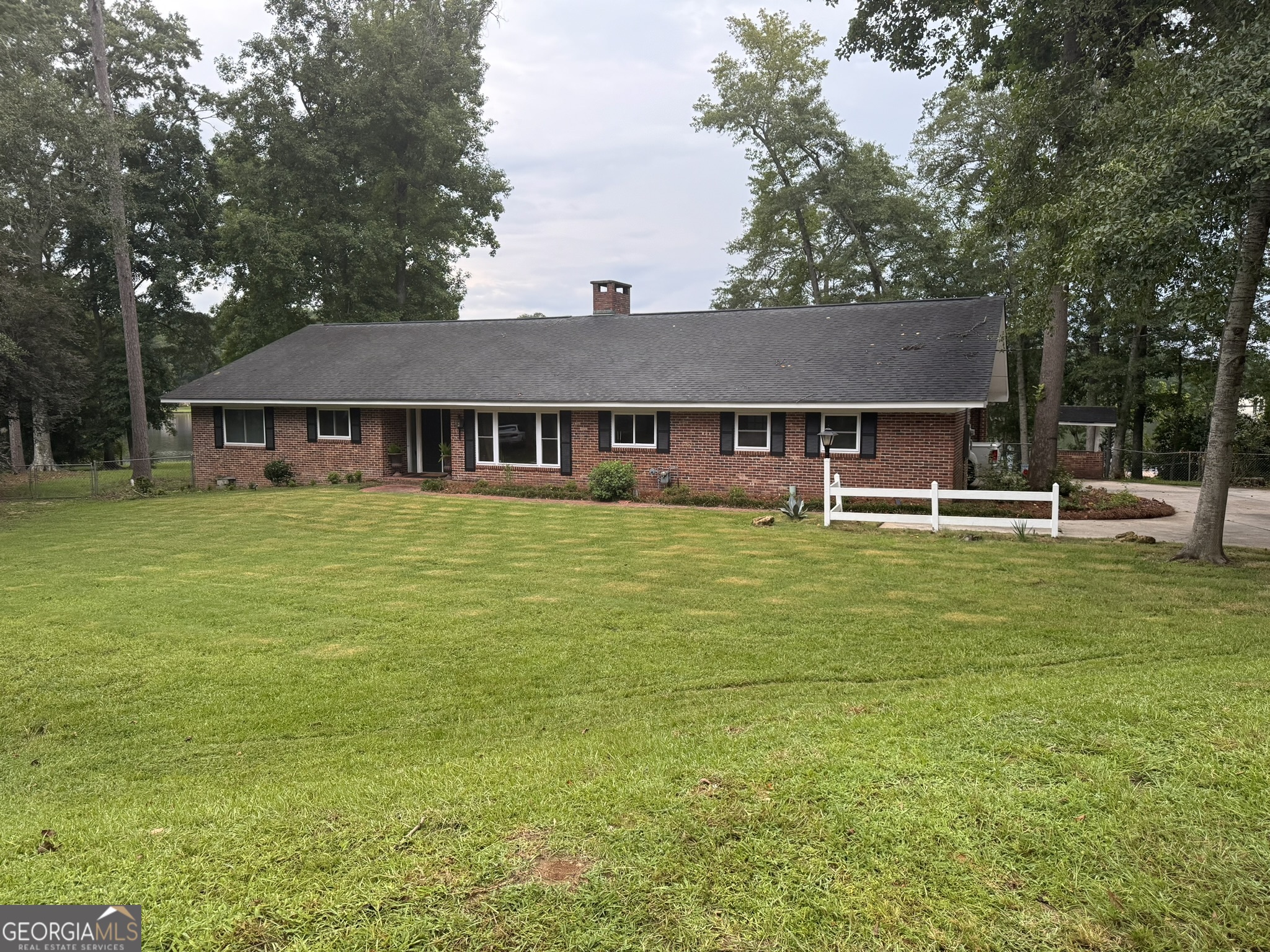 a front view of a house with swimming pool having outdoor seating
