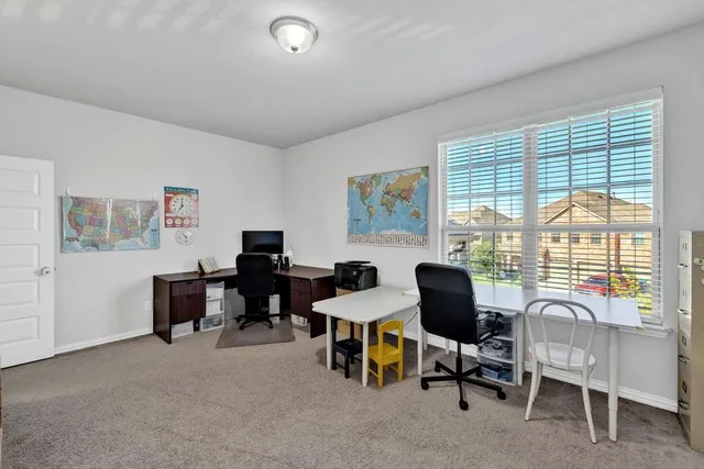 a view of a livingroom with workspace and a couch