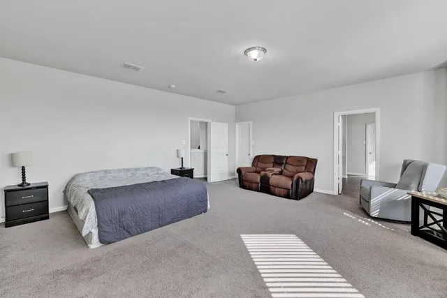 a bedroom with two beds and a desk