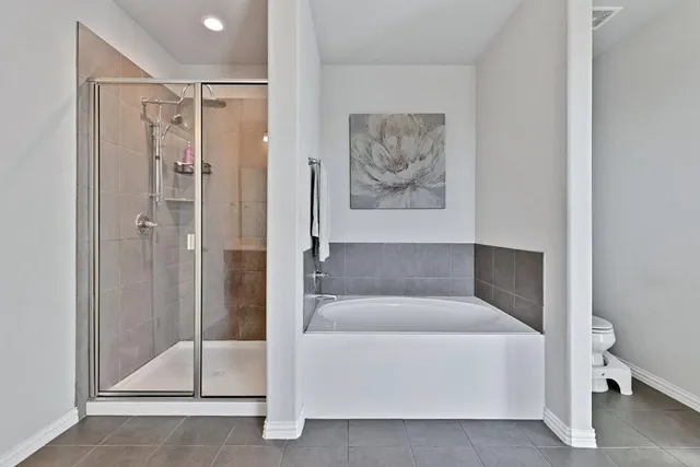 a living room with furniture a couch and a potted plant on dresser