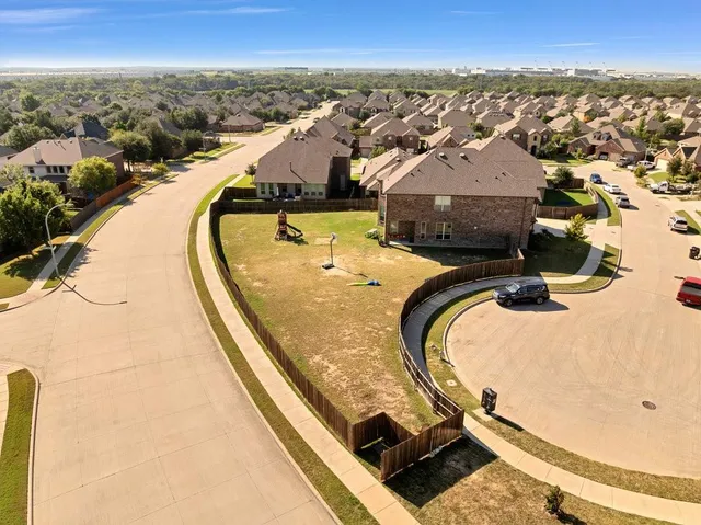 a view of swimming pool with lawn chairs and iron fence