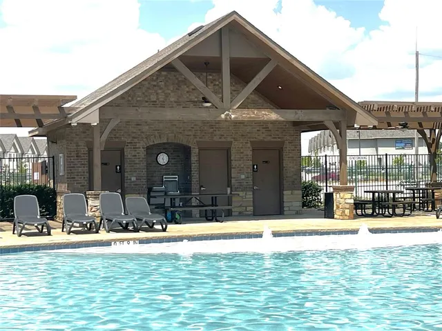 a view of swimming pool with outdoor seating and yard